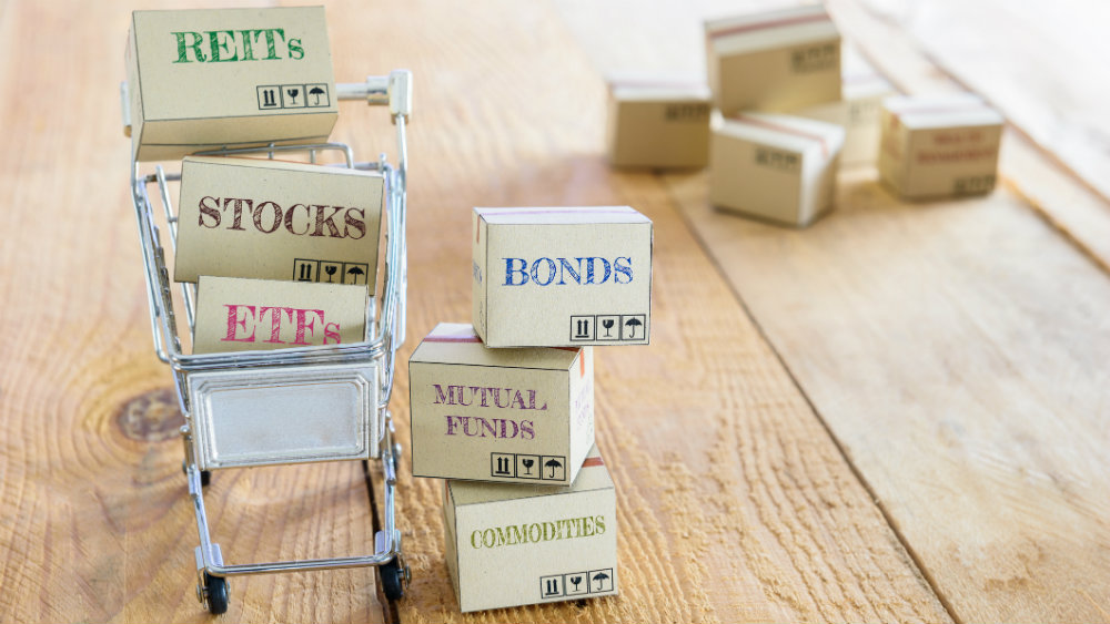 Shopping card with boxes labelled REITs, ETFs, Bonds, Stocks