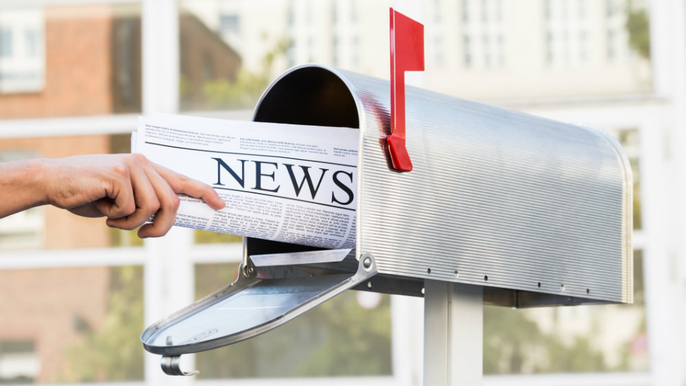 Person Hands Opening Mailbox To Remove Newspaper