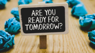Handwriting text writing Are You Ready For Tomorrow question. Concept meaning Preparation to the future Motivation Stand blackboard with white words behind blurry blue paper lobs woody floor.