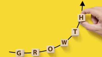 GROWTH DICES PLACED ON AN UPWARD RISING ARROW