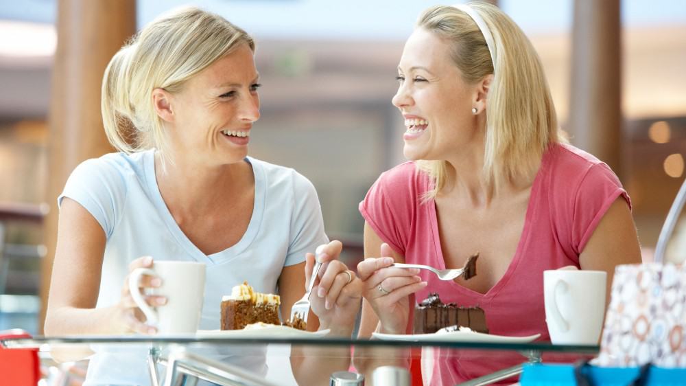 Female friends enjoying their dessert together at a mall