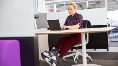 edit Woman in skates works on laptop