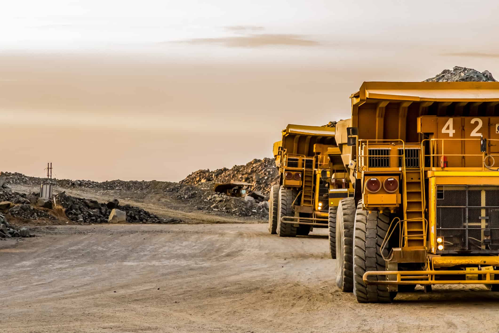 Super sized rock trucks take a load of platinum rich rock into the crusher.