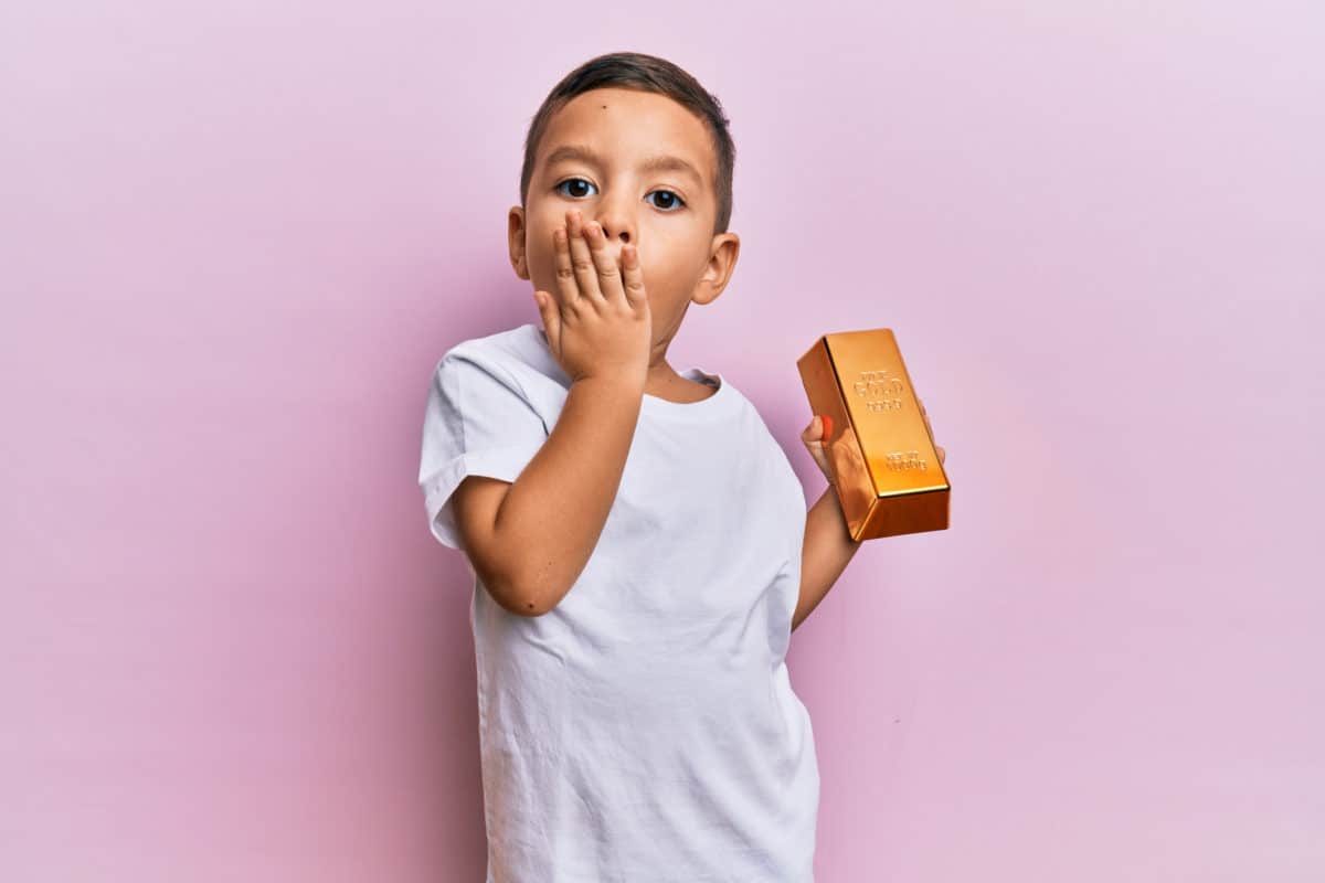 todder holds a gold bar