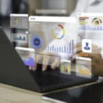 An analyst uses a computer and dashboard for data business analysis and Data Management System with KPI and metrics connected to the database for technology finance, operations, sales, marketing, and artificial intelligence.