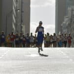 Woman running in front of pack in marathon