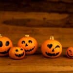 group of jack-o-lanterns smile together