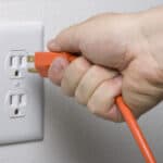 electrical cord plugs into wall socket for more energy