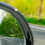 looking backward in car mirror