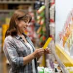 shopper looks at paint color samples at home improvement store