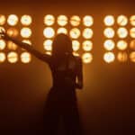 dancer in front of lights brings excitement and heat