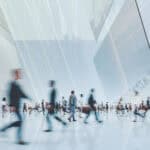 workers walk through an office building