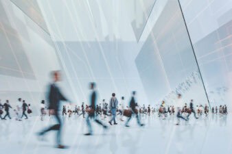 workers walk through an office building