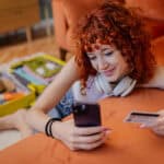 young adult uses credit card to shop online