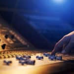 sound engineer adjusts audio on board