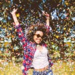 person enjoys shower of confetti outside