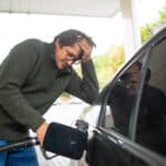 customer fills up car with gasoline