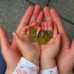 holding coins in hand for the future