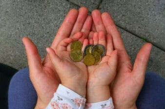 holding coins in hand for the future