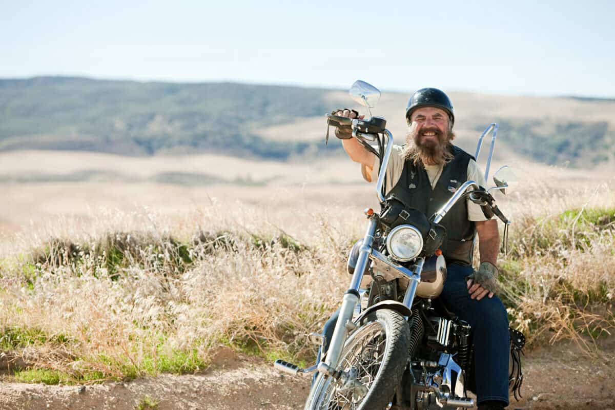 motorcycle rider smiles on bike