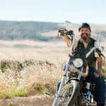 motorcycle rider smiles on bike