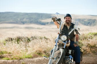 motorcycle rider smiles on bike