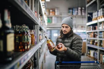 customer comparison shops in liquor store