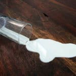 dairy milk spills out of glass