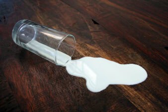 dairy milk spills out of glass