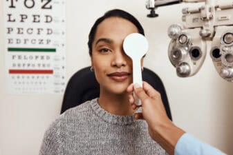 patient tests her eyes with a vision test at a doctor