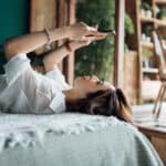 woman relaxes with phone